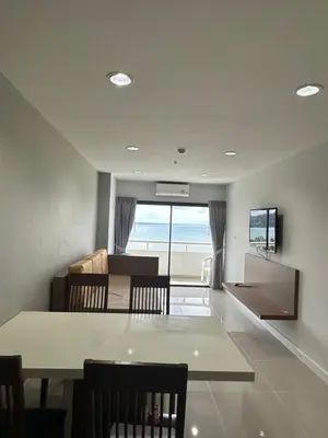 a dining room and living room with a view of the ocean at Patong Tower Apartments sea view 2B in Patong Beach