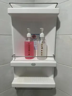 a white shelf with two bottles of soap in a bathroom at Patong Tower Apartments sea view 2B in Patong Beach