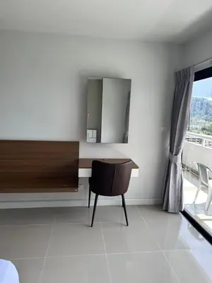 a room with a desk and a chair and a mirror at Patong Tower Apartments sea view 2B in Patong Beach