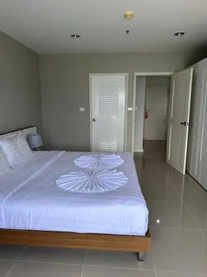 a bedroom with a large bed with a white comforter at Patong Tower Apartments sea view 2B in Patong Beach