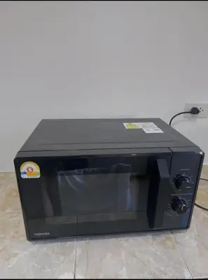 a black microwave oven sitting on top of a floor at Smile house in Karon Beach