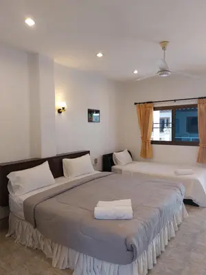 a bedroom with two beds and a window at Smile house in Karon Beach