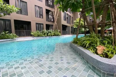 a swimming pool in the middle of a building at Mode apartment central Phuket in Phuket Town