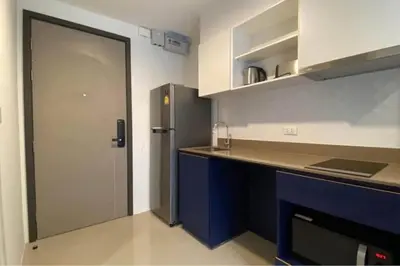 a kitchen with a blue counter and a refrigerator at Mode apartment central Phuket in Phuket Town