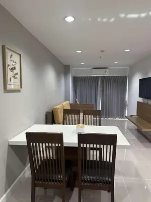 a dining room with a white table and chairs at Patong tower sea view in Patong Beach