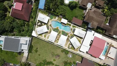 an overhead view of a yard with houses and a swimming pool at The Hidden Lagoon Resort - Exclusively for Adults in Rawai Beach