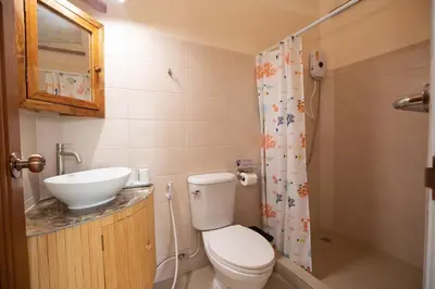 a small bathroom with a toilet and a sink at The Hidden Lagoon Resort - Exclusively for Adults in Rawai Beach