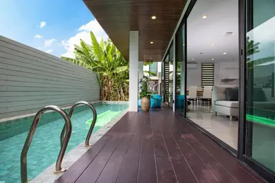 a swimming pool in the middle of a house at Lively Stay at Vibrant Kata, 4BR Pool Villa B2 near Beach - UTK2 in Kata Beach