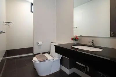 a bathroom with a white toilet and a sink at Lively Stay at Vibrant Kata, 4BR Pool Villa B2 near Beach - UTK2 in Kata Beach