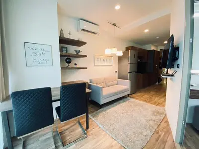 a living room with a table and a couch at A11 Oceana Kamala in Kamala Beach