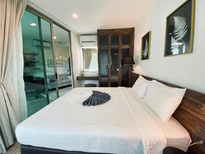 a bedroom with a large bed with white sheets at A11 Oceana Kamala in Kamala Beach
