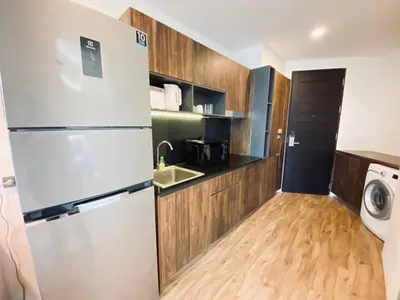 a kitchen with a refrigerator and a sink at A11 Oceana Kamala in Kamala Beach