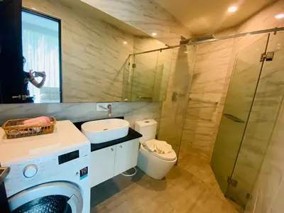 a bathroom with a washing machine and a sink at A26 Oceana Kamala in Kamala Beach