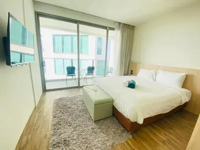 a bedroom with a large bed and a large window at A43 Oceana kamala in Kamala Beach