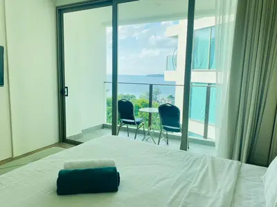 a bedroom with a bed and a view of the ocean at A43 Oceana kamala in Kamala Beach