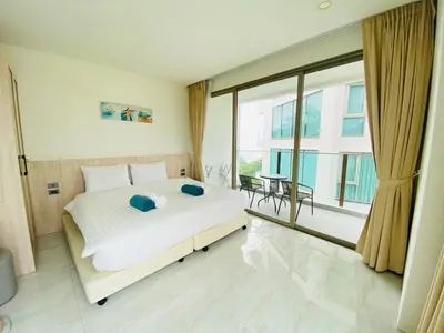 a bedroom with a white bed and a large window at A45 Oceana Kamala in Kamala Beach