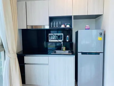 a small kitchen with a refrigerator and a sink at A45 Oceana Kamala in Kamala Beach