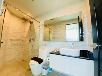 a bathroom with a toilet and a sink and a shower at A45 Oceana Kamala in Kamala Beach