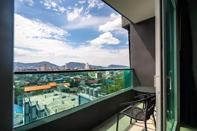 a balcony with a view of a city at Private sea view apartment at Emerald Terrace in Patong Beach