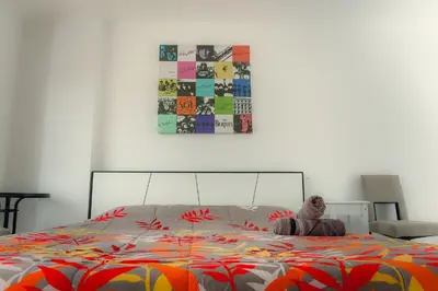 a bedroom with a bed with a colorful comforter at KC Kamala Guesthouse in Kamala Beach