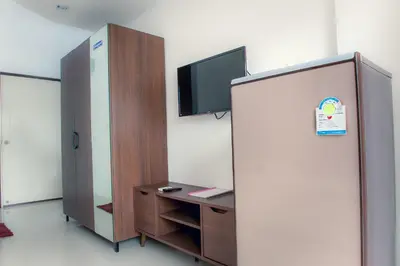 a room with a partition with a tv and a desk at KC Kamala Guesthouse in Kamala Beach