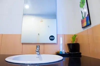 a bathroom with a sink and a mirror at KC Kamala Guesthouse in Kamala Beach