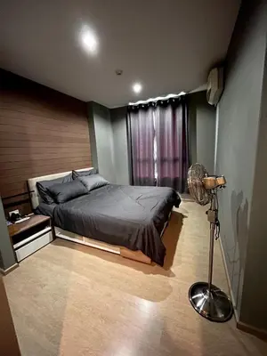 a bedroom with a bed and a floor fan at ZcapeX2 condominium in Bang Tao Beach