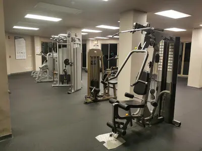 a gym with several treadmills and machines at Veloche Karon palm in Phuket Town