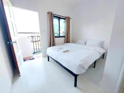 a bedroom with a bed in a room with a window at XX BAO Patong Beach Phuket 3 in Patong Beach