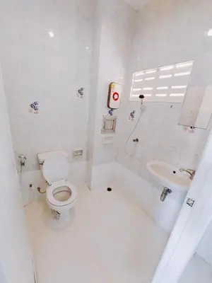 a white bathroom with a toilet and a sink at XX BAO Patong Beach Phuket 3 in Patong Beach