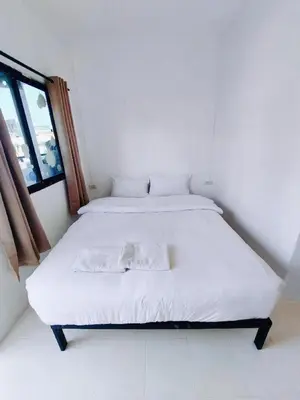 a white bed in a room with a window at XX BAO Patong Beach Phuket 3 in Patong Beach