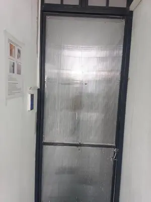 a metal door in a room with a wall at XX BAO Patong Beach Phuket 3 in Patong Beach