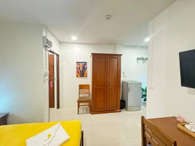 a room with a bed and a sliding glass door at Pupa Rooms in Patong Beach