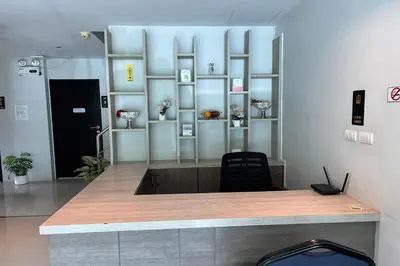 a reception desk with a chair in a room at JZ Patong in Patong Beach