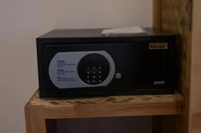 a black microwave sitting on a wooden stand at Coral Lagoon Pool Villa Rawai - Adult Only in Rawai Beach
