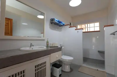 a bathroom with a sink and a toilet and a mirror at Coral Lagoon Pool Villa Rawai - Adult Only in Rawai Beach