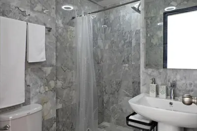 a bathroom with a sink and a toilet and a shower at Mai Khao Beach Condo by Capital Pro in Mai Khao Beach