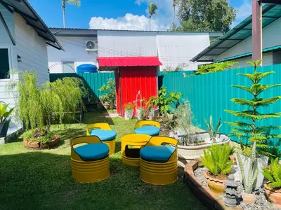 a group of stools sitting in a yard at Sunshine guesthouse in Ban Saiyuan (1)