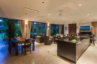 a large kitchen and living room with a table and chairs at 23 - Seaside Villa Retreat in Phuket Town