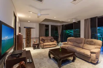 a living room with two couches and a flat screen tv at 23 - Seaside Villa Retreat in Phuket Town