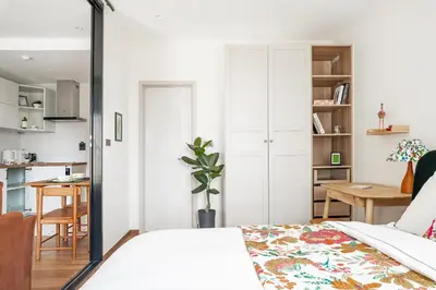 a bedroom with a bed and a desk and a kitchen at Title Halo Time for Jungle 40m2 King Bed Pool in Nai Yang Beach
