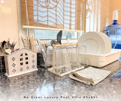 a kitchen counter with dishes and other kitchen utensils at Luxury Pool Villa 5 mins to Phuket Old Town in Ban Lo Long
