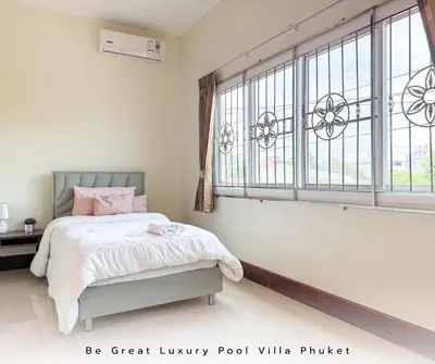 a bedroom with a bed and a large window at Luxury Pool Villa 5 mins to Phuket Old Town in Ban Lo Long