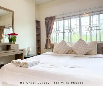 a bedroom with a large white bed with a large window at Luxury Pool Villa 5 mins to Phuket Old Town in Ban Lo Long