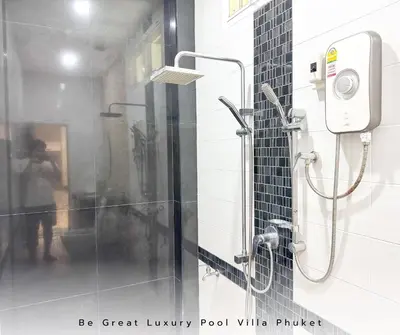 a shower with a glass door in a bathroom at Luxury Pool Villa 5 mins to Phuket Old Town in Ban Lo Long