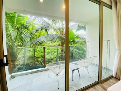 a room with a large window and two chairs on a balcony at A16 Oceana Kamala in Kamala Beach