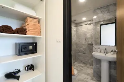 a bathroom with a walk in shower and a sink at MBC by Capital Pro in Mai Khao Beach