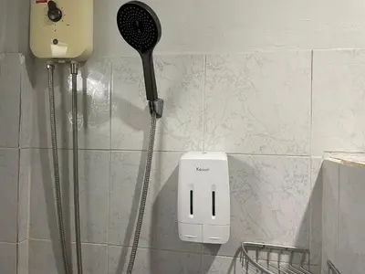 a hair dryer on the wall of a bathroom at Yada House twin bed in Nai Yang Beach