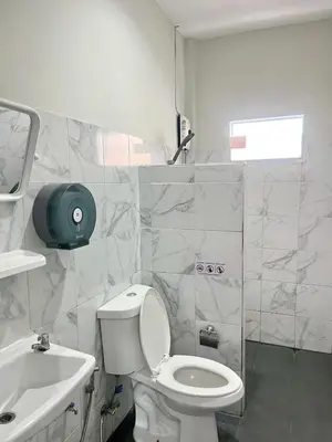a bathroom with a white toilet and a sink at Yada House twin bed in Nai Yang Beach