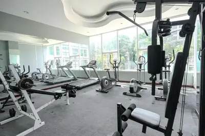a gym with a bunch of treadmills and machines at Golden Manora Hotel Bangtao Beach Phuket in Bang Tao Beach